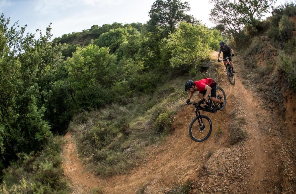 Two riders shralping a corner on e-bikes